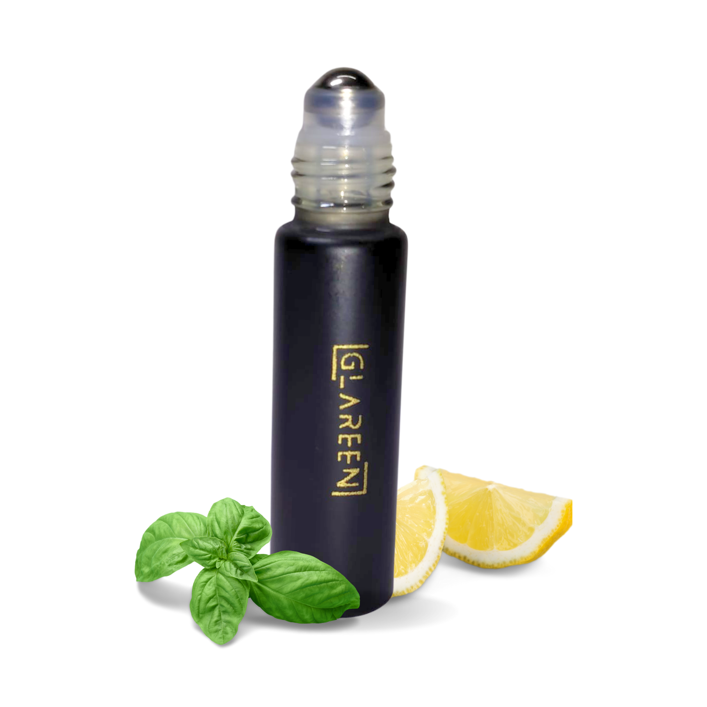 A black roller bottle of Zenith Attar with a metallic ball, labeled GREEN, is placed next to fresh basil leaves and two lemon wedges on a white background.