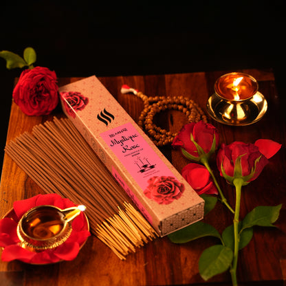 A box of Rose, Sandal & Jasmine Agarbatti Incense Sticks  rose agarbatti incense stick burning in wooden holder